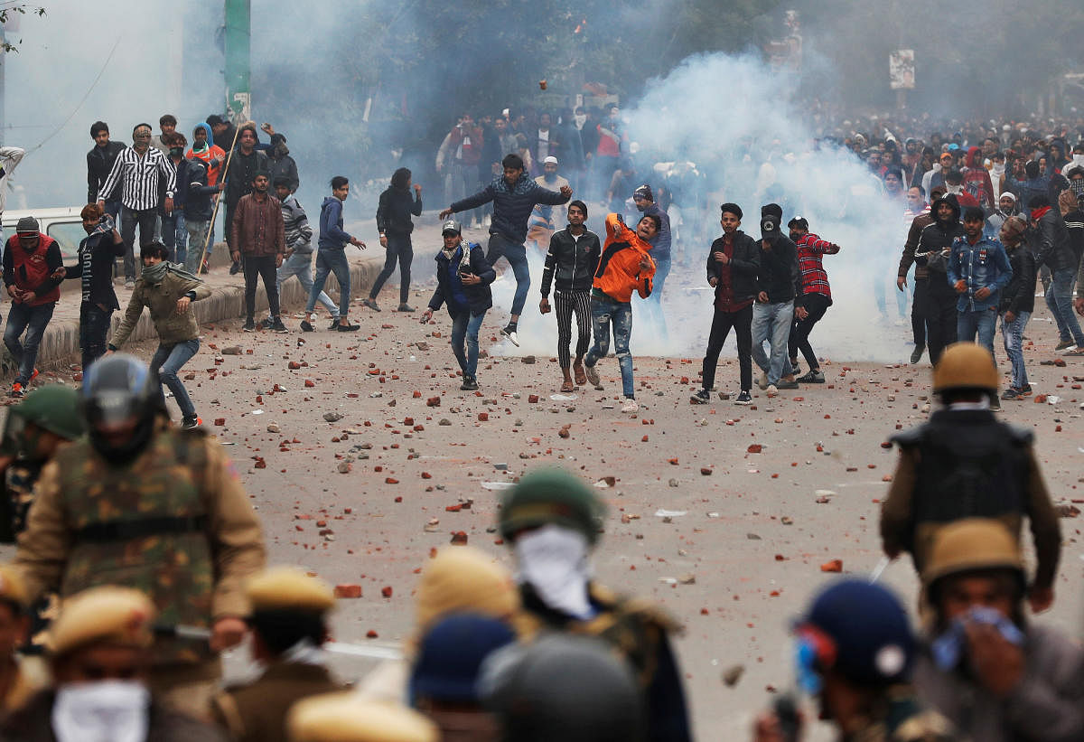 Protestors indulge in stone-pelting during an anti-CAA protest in Seelampur, Delhi, on Tuesday. Reuters
