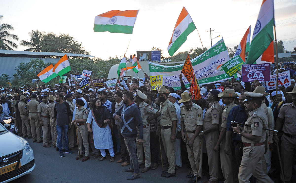 People protest against CAA at Bannerghatta Main Road in Bengaluru on Wednesday. | DH Photo: Pushkar V
