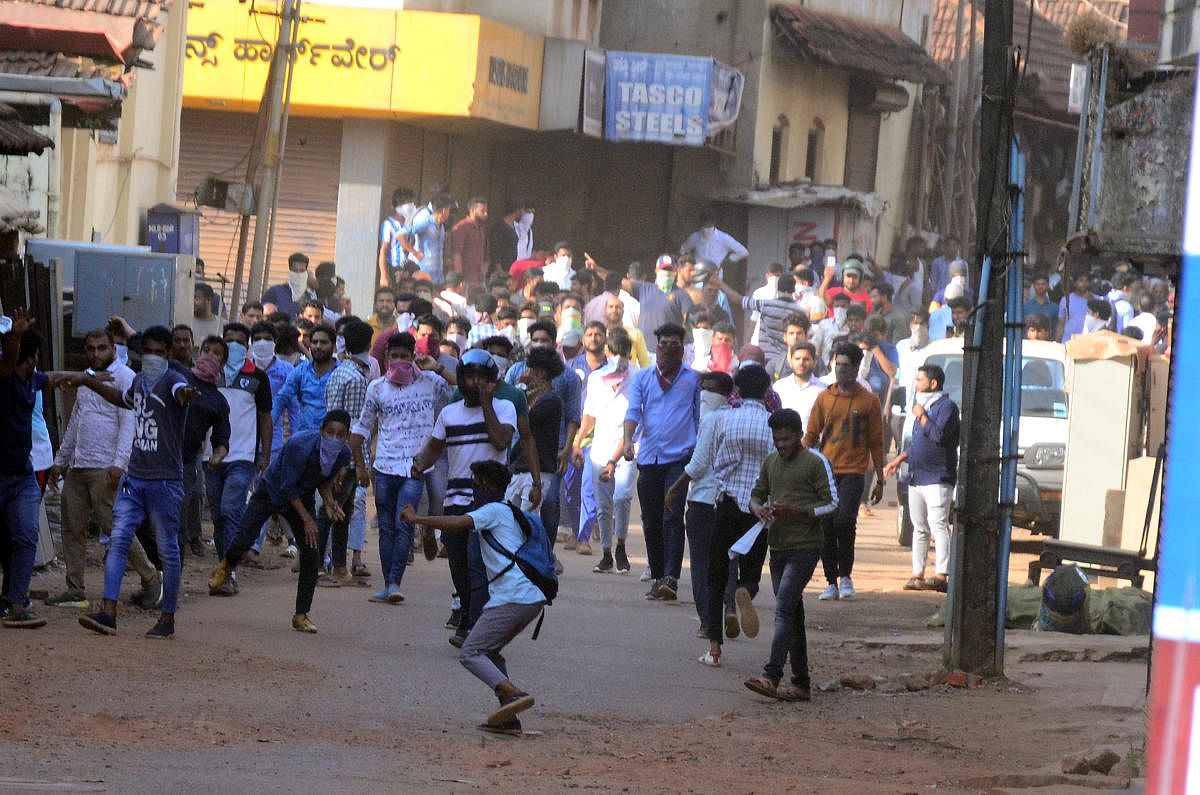 Protesters pelt stones at police during a protest against the Citizenship Amendment Act in Mangaluru on Thursday.