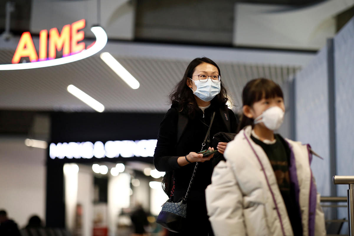 Tourists from an Air China flight from Beijing wear protective masks as they arrive at Charles de Gaulle airport in Paris, France, January 26, 2020. (Reuters Photo)