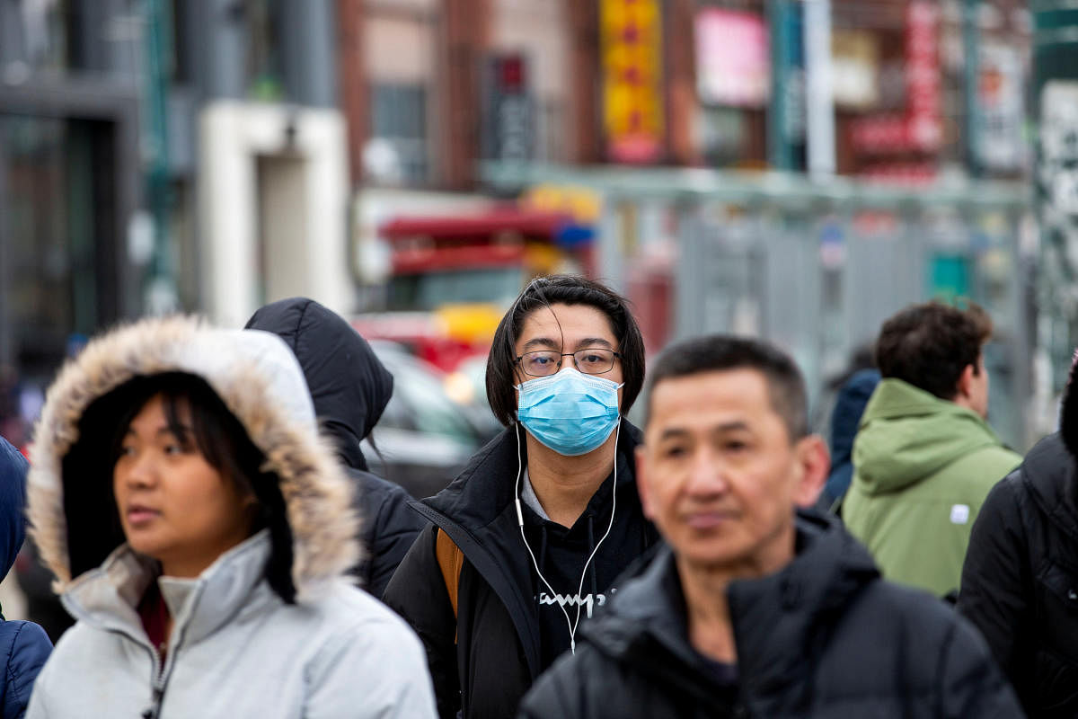 A man wearing a mask walks in the Chinatown district of downtown Toronto, Ontario, after 3 patients with novel coronavirus were reported in Canada January 28, 2020. (Reuters photo)
