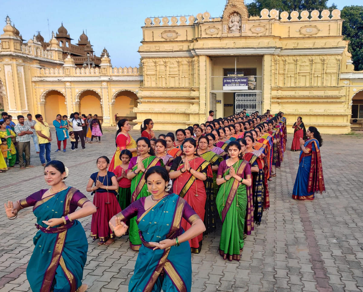 A file picture of singers and dancers from the Raghuleela School of Music in Mysuru taking out a procession near the palace to create awareness on civic issues. They will perform in Bengaluru on Friday.
