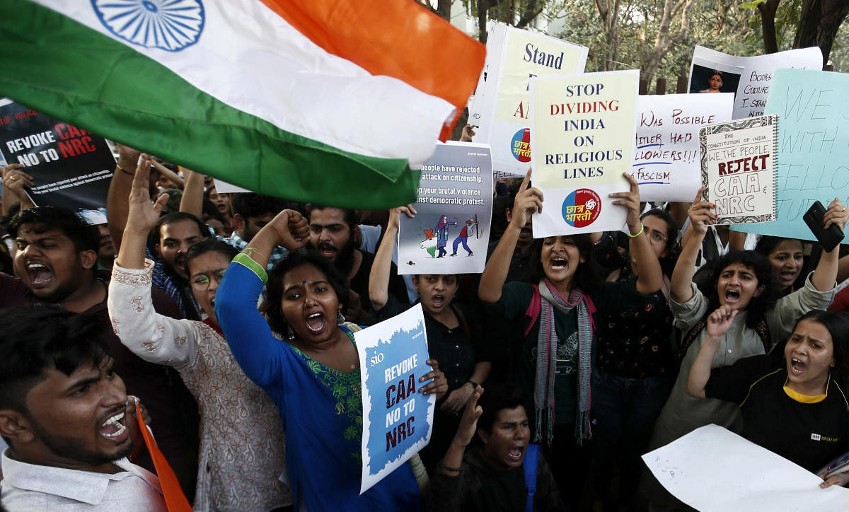 Students hold placards and shout slogans in solidarity with Jamia Millia Islamia university students after police entered the campus on Sunday in New Delhi, following a protest against a new citizenship law, in Mumbai. PTI