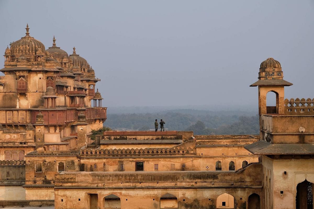 In this picture taken on December 14, 2018, Indian tourists take pictures at Orchha Fort complex in Orchha, in the Indian state of Madhya Pradesh. (AFP Photo)