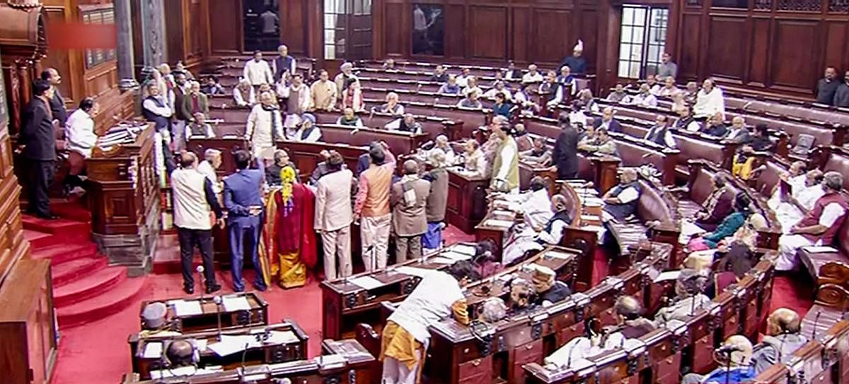 Opposition members protest in the well of Rajya Sabha during the Budget Session of Parliament, in New Delhi, Tuesday, Feb. 4, 2020. (PTI Photo)