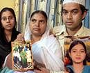 A file photo of  Shamima Kausar, mother of Ishrat Jahan (inset), holds a group photo of the family while standing with her daughter and son