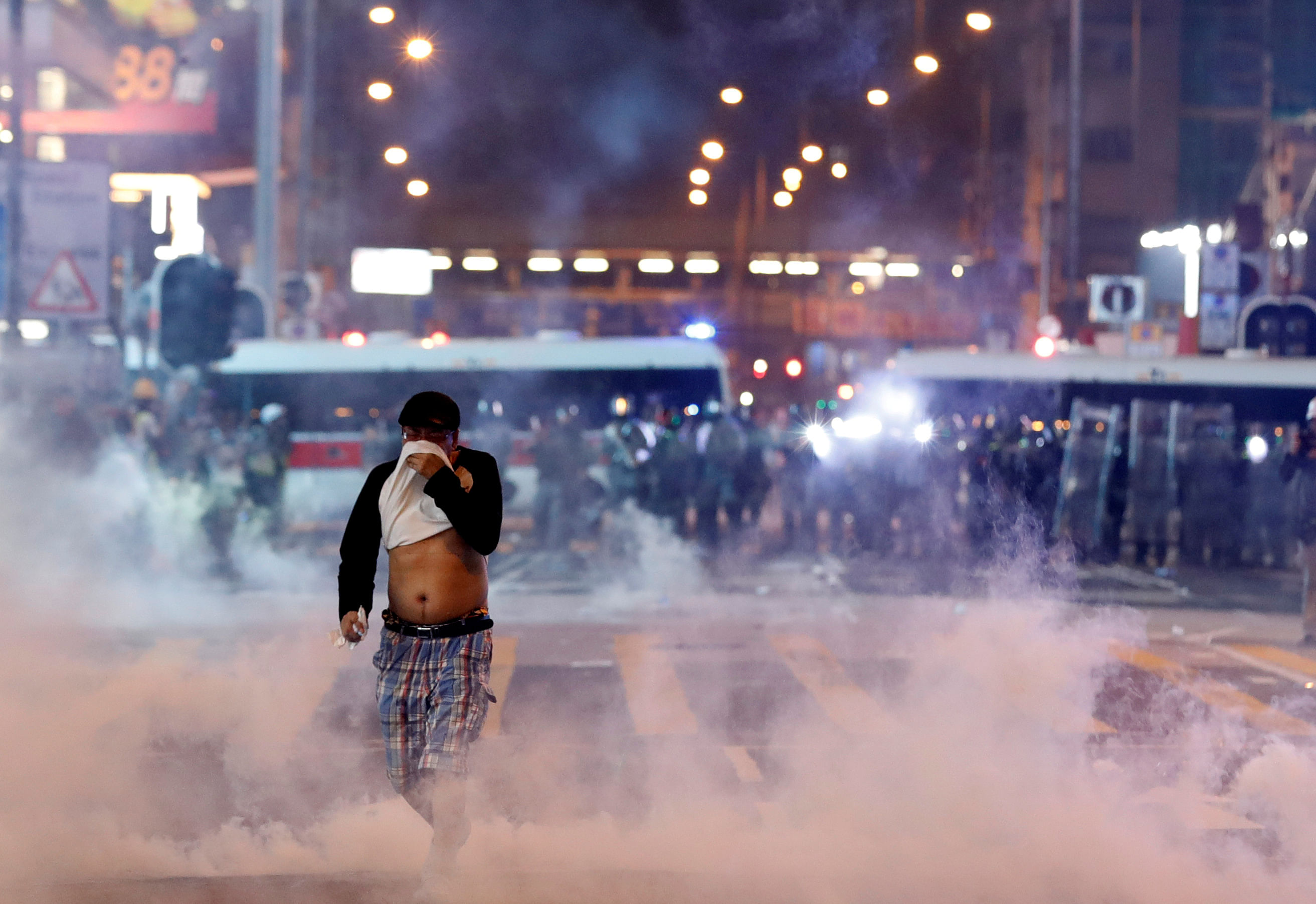 A man runs among the tear gas during a protest in Hong Kong, China. (Reuters Photo)