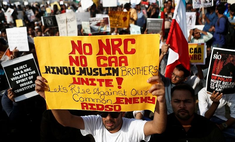 Demonstrators hold placards during a protest against a new citizenship law in Mumbai. (Reuters Photo)