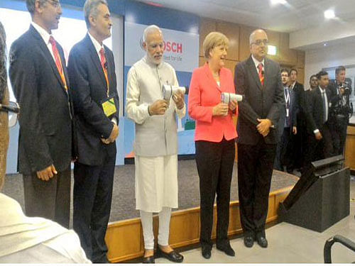 PM Modi and Chancellor Merkel at Bosch, image courtesy Twitter