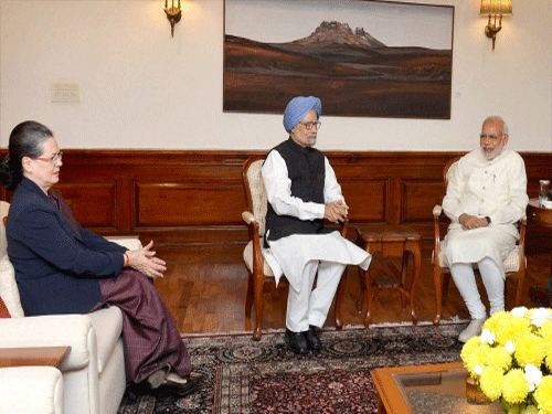 Prime Minister Narendra Modi with former Prime Minister Manmohan Singh and Congress President Sonia Gandhi during a meeting in New Delhi on Friday. PTI Photo.