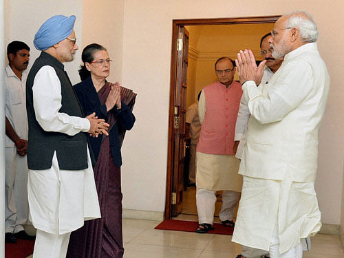 Prime Minister Narendra Modi greets former prime minister Manmohan Singh and Congress President Sonia Gandhi at 7 Race Course Road in New Delhi on Friday. Union Finance Minister Arun Jaitley and Union Minister of Urban Development M Venkaiah Naidu are also seen. PTI Photo