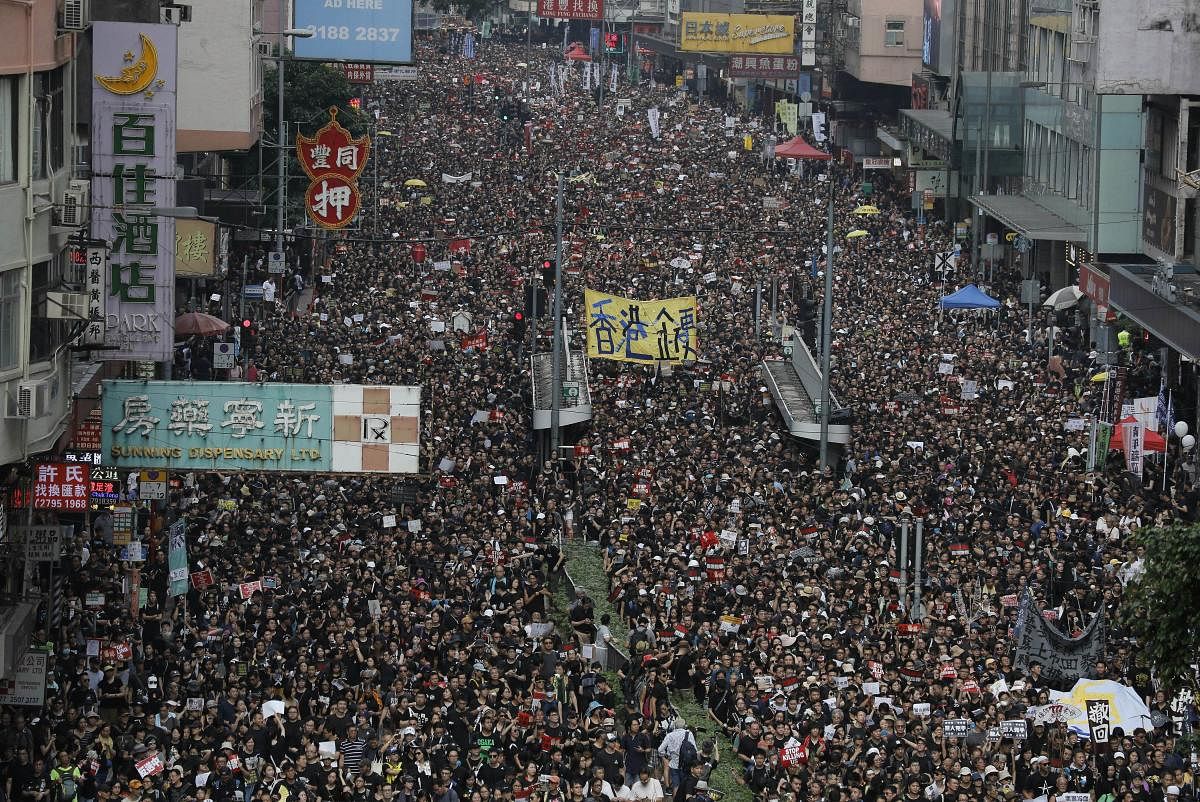 Tens of thousands of protesters march through the streets as they continue to protest an extradition bill, Sunday, June 16, 2019, in Hong Kong. Hong Kong residents were gathering Sunday for another massive protest over an unpopular extradition bill that has highlighted the territory's apprehension about relations with mainland China, a week after the crisis brought as many as 1 million into the streets. AP/PTI