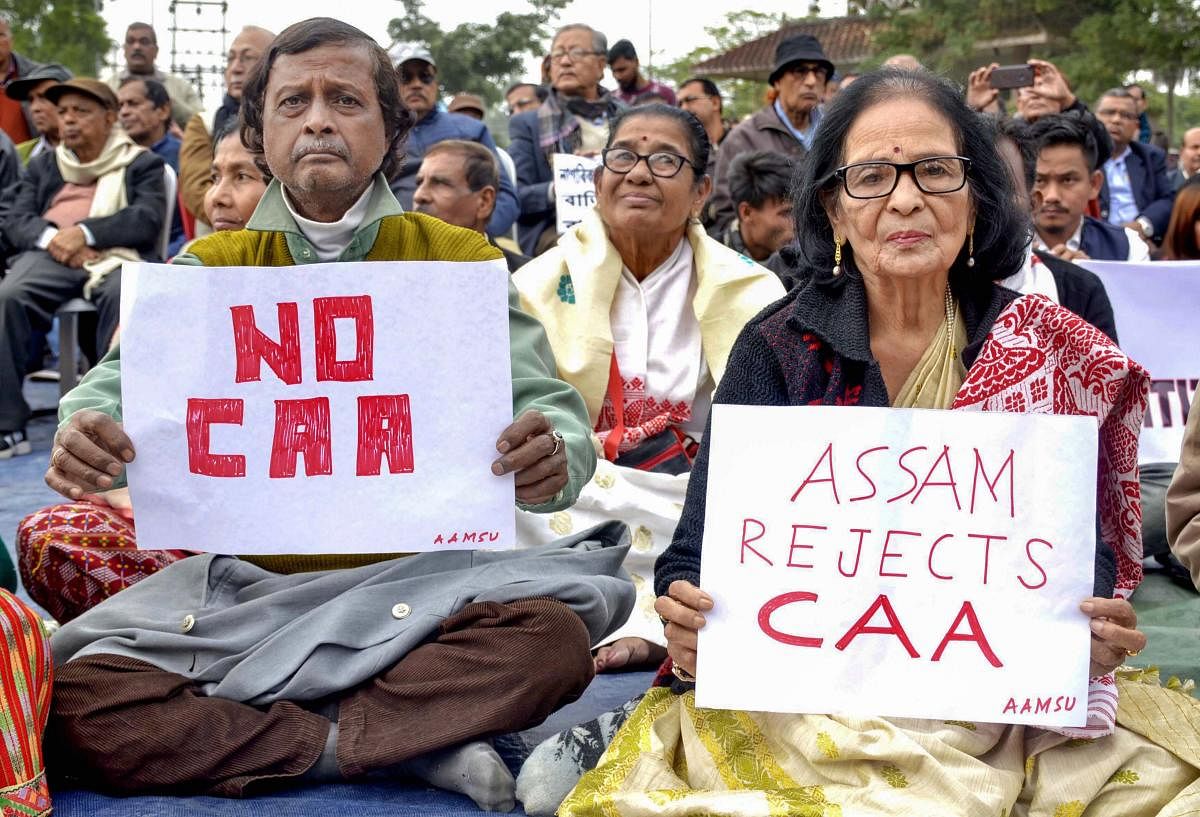 Senior citizens display placards during a protest against the Citizenship (Amendment) Act, at Latashil Playground in Guwahati. PTI