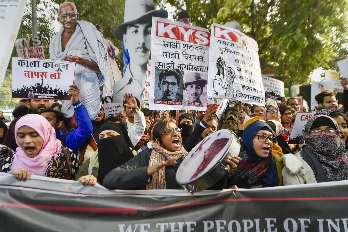  Protestors display placards and raise slogans as they gather for a demonstration demanding withdrawal of Citizenship Amendment Act (CAA). PTI