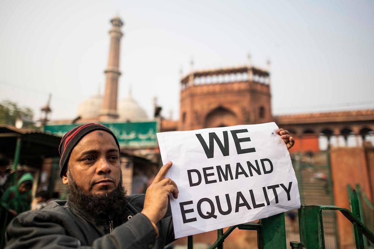 A protester displays a placard during a demonstration against India's new citizenship law outside the Jama Masjid mosque in New Delhi on December 27, 2019. Photo/AFP