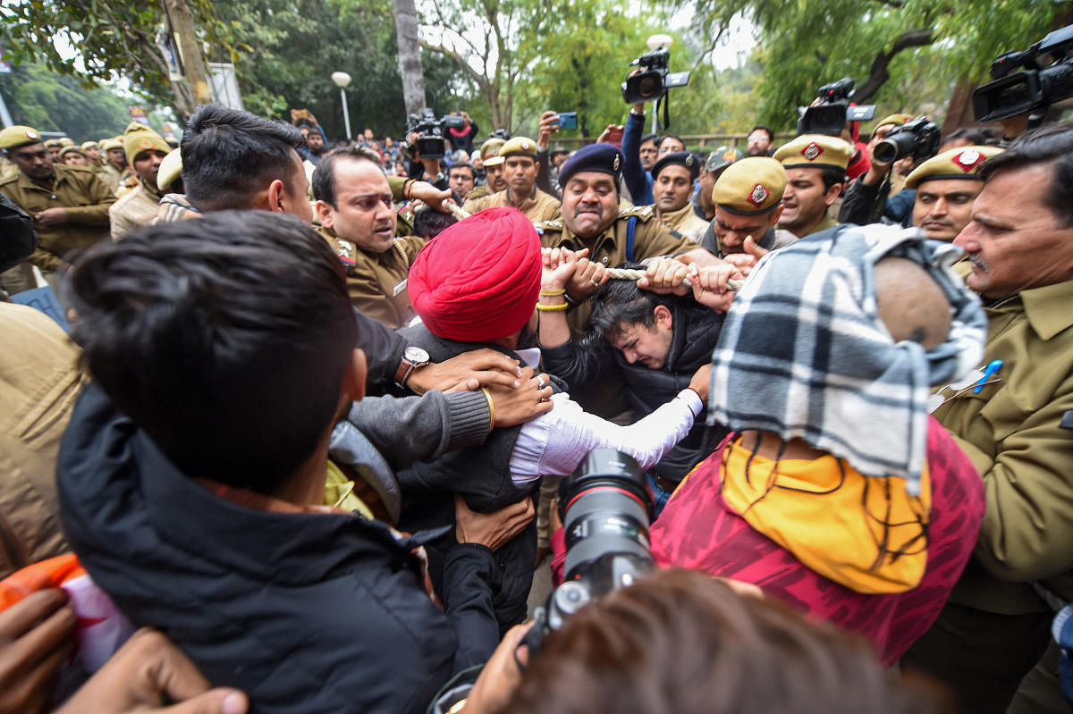 Police personnel detain members of National Students' Union of India (NSUI), at Delhi University campus in New Delhi, Monday, Dec. 16, 2019. (PTI Photo)