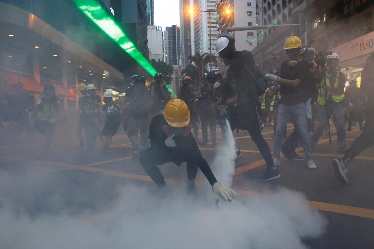 Protesters hurled bricks at officers and ignored warnings to leave the Sham Shui Po area before tear gas was deployed, police said, calling the march an "unauthorized assembly." (Reuters)