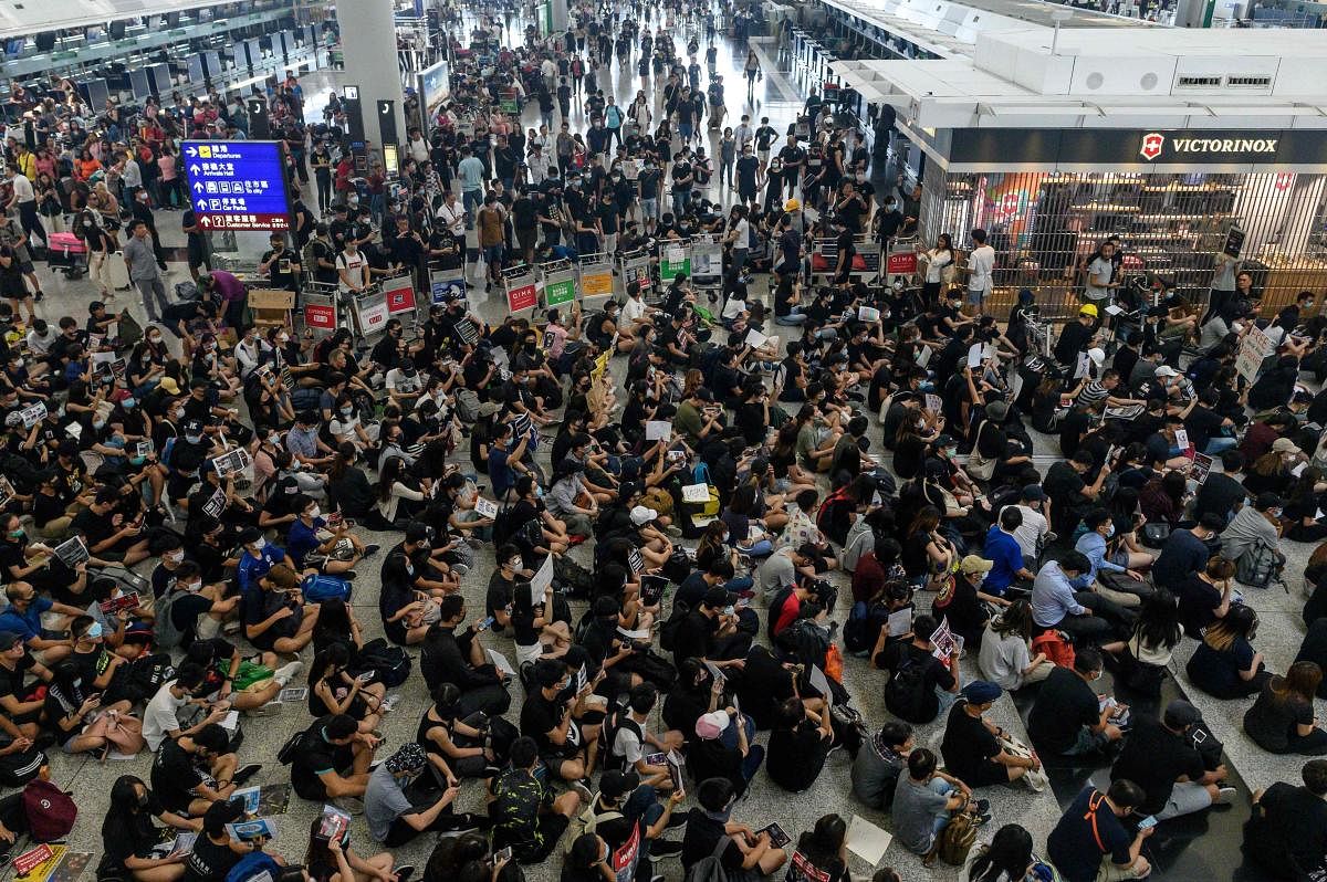 The Hong Kong Airport on Monday cancelled flights after protesters stormed in the arrival halls wearing eye patches and bandages opposing a bill that allows extraditions to mainland China. (AFP Photo)