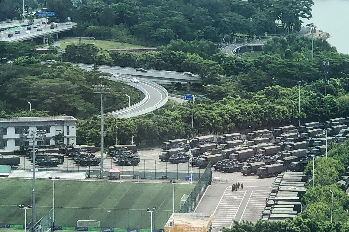 Trucks and armoured personnel carriers are seen outside the Shenzhen Bay stadium in Shenzhen, bordering Hong Kong in China's southern Guangdong province, on August 15, 2019.Photo by STR/AFP