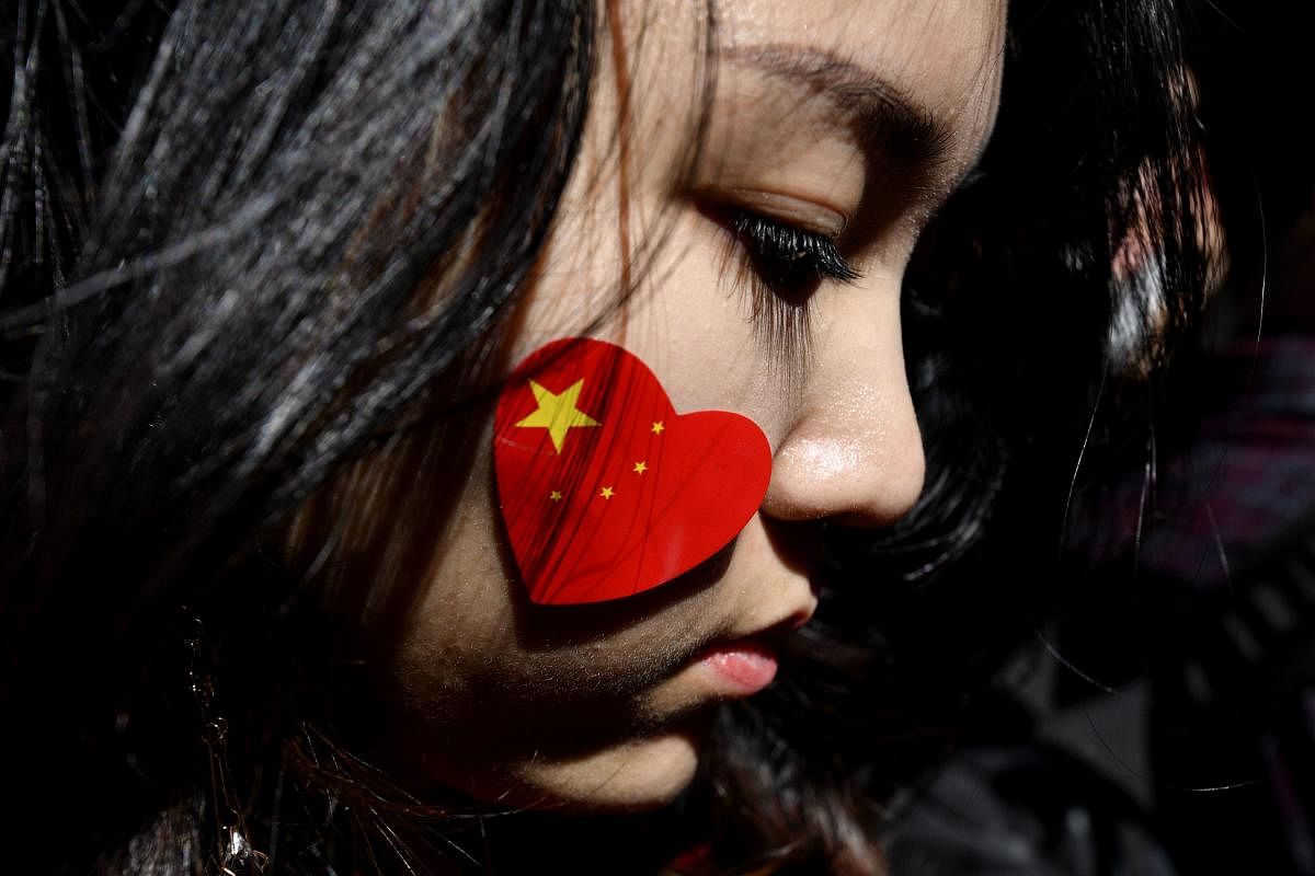 A pro-China activist marches on the streets of Sydney during a rally against ongoing protests in Hong Kong. AFP Photo