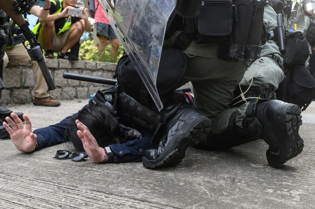 Police arrest a protester at Kowloon Bay in Hong Kong's Kwun Tong district on August 24, 2019, during clashes in the latest opposition to a planned extradition law that has since morphed into a wider call for democratic rights in the semi-autonomous city. AFP