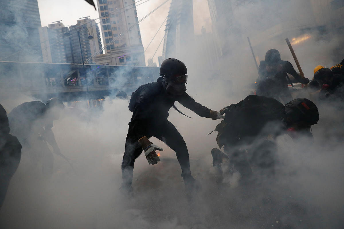 Demonstrators are surrounded by tear gas during a protest in Tsuen Wan, in Hong Kong (Reuters photo)