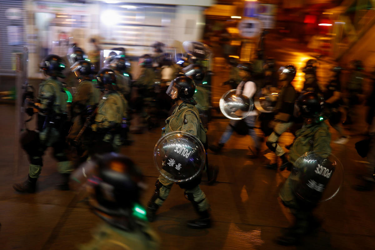 Police advance during clashes with anti-extradition bill protesters in Hong Kong, China August 25, 2019. Picture taken August 25, 2019. Picture taken with long shutter speed. REUTERS/Thomas Peter