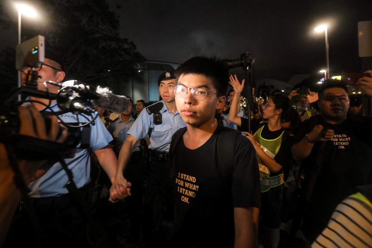 Pro-democracy activist Joshua Wong looks on as he confronts police after taking part in a march to the West Kowloon rail terminus against the proposed extradition bill in Hong Kong. He was arrested on August 30, 2019, his party said, a day ahead of a plan