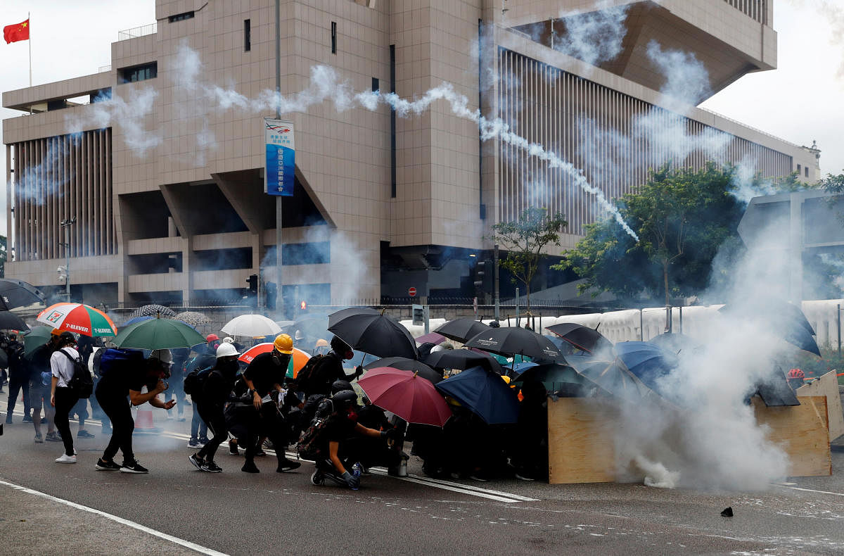 Demonstrators take cover as police fires tear gas during a protest in Hong Kong. Reuters photo