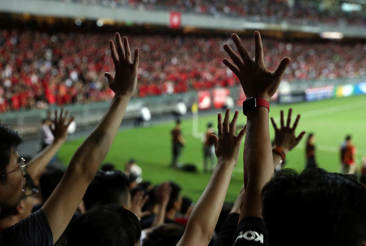 Soccer fans gesture their hands in support of anti-government protesters during a football World Cup qualifier match between Hong Kong and Iran, at Hong Kong Stadium, China September 10, 2019. (REUTERS)