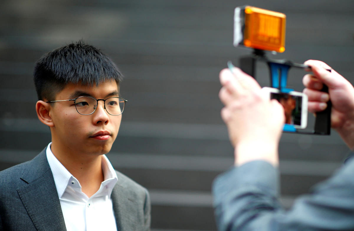 Hong Kong's pro-democracy activist Joshua Wong poses after a news conference in Berlin. Reuters