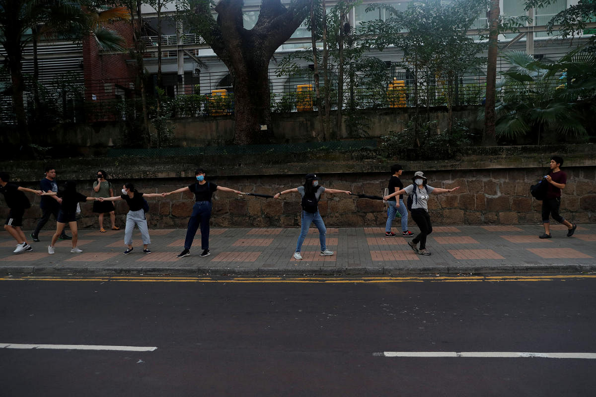 Anti-government demonstrators form a human chain during a protest in Tsim Sha Tsui district, in Hong Kong. Reuters