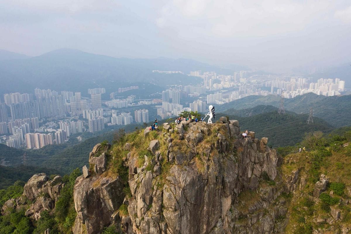 This aerial photo shows a four-metre statue known as "Lady Liberty" (C), after it was hauled by pro-democracy protesters to the top of Lion Rock, one of the Hong Kong's most famous mountain tops, on October 13, 2019, announcing that the peak would be its