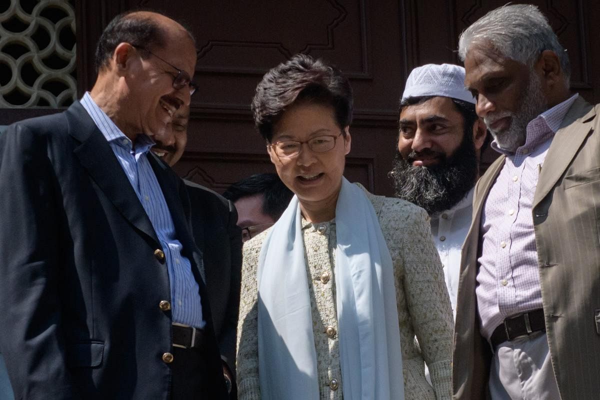 Hong Kong's Chief Executive Carrie Lam (C) exits the Kowloon Mosque, or Kowloon Masjid and Islamic Centre, in the Tsim Sha Tsui district in Hong Kong. AFP