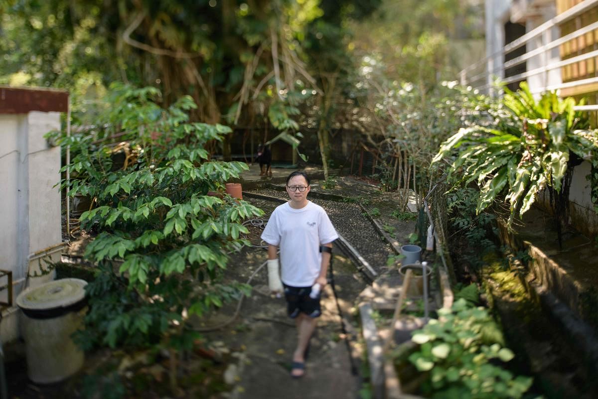 In a photo taken with a tilt-shift lens on October 18, 2019 labour unionist Stanley Ho, 35, who had both hands smashed with metal rods during an attack, poses for a portrait in the Sai Kung district of Hong Kong. AFP