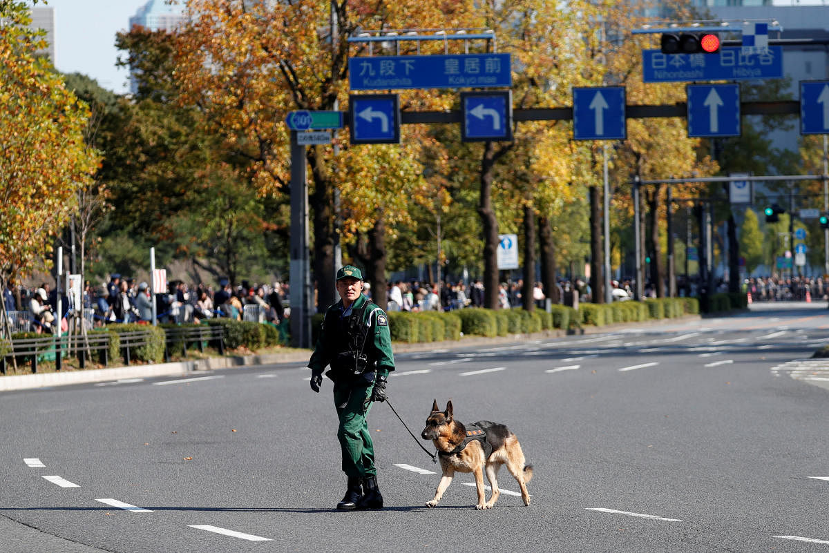 A police officer patrols with a police dog. (Photo: REUTERS)