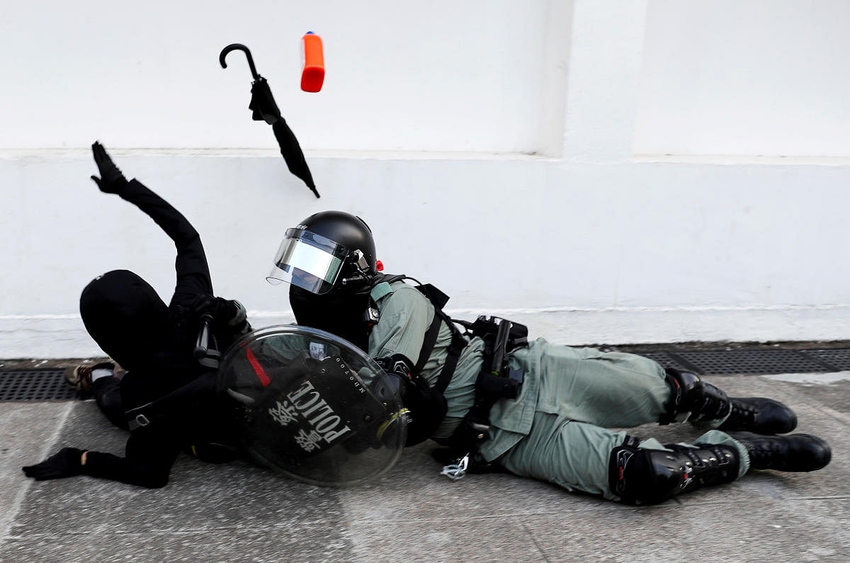 A riot police officer tries to subdue a protester during an anti-government demonstration in Hong Kong. (REUTERS)