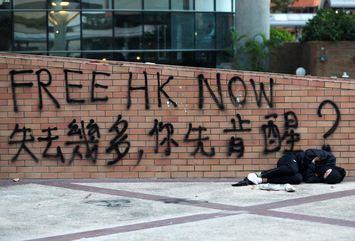 A protester sleeps at the Hong Kong Polytechnic University campus during protests in Hong Kong, China, November 19, 2019. (Photo by Reuters)