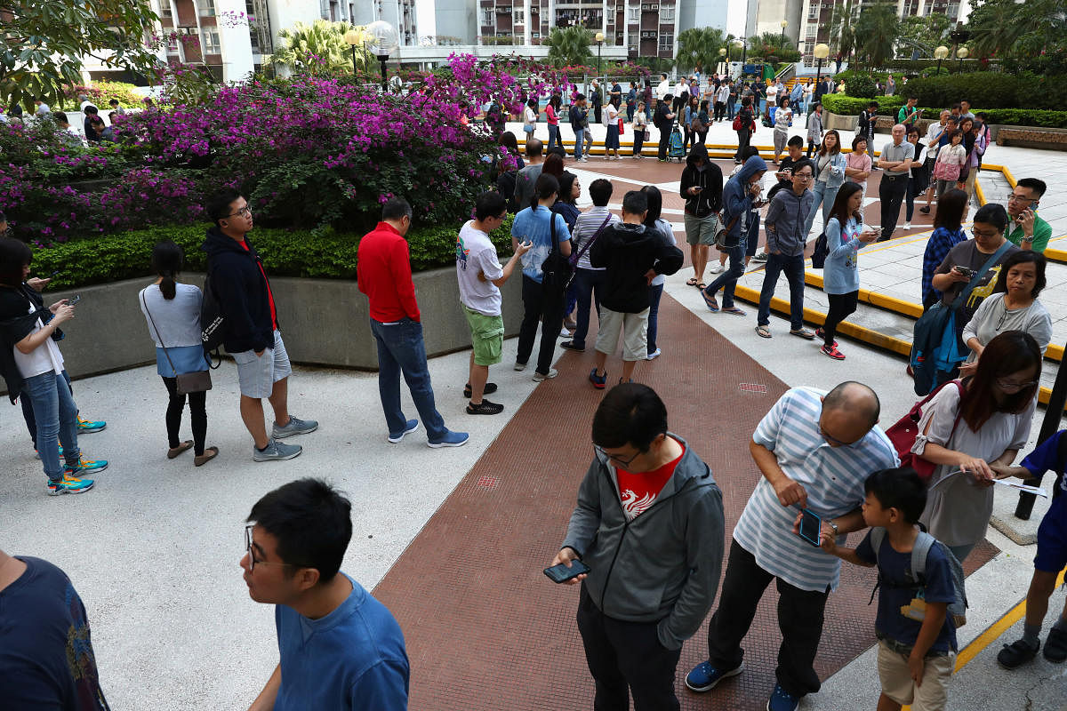 Voters queue to vote at a polling station during district council local elections on Hong Kong Island, China. (Reuters Photo)