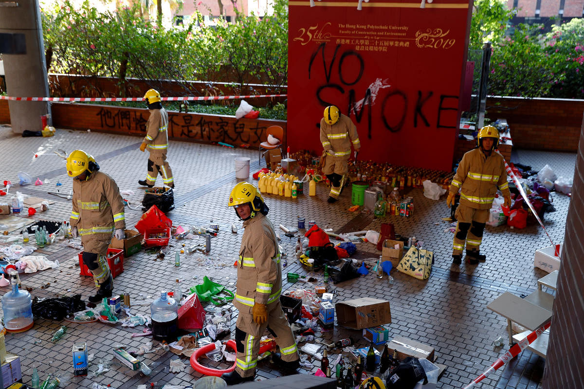 Firefighters examine debris left by protesters at the campus of the Polytechnic University (PolyU) in Hong Kong, China. Reuters Photo