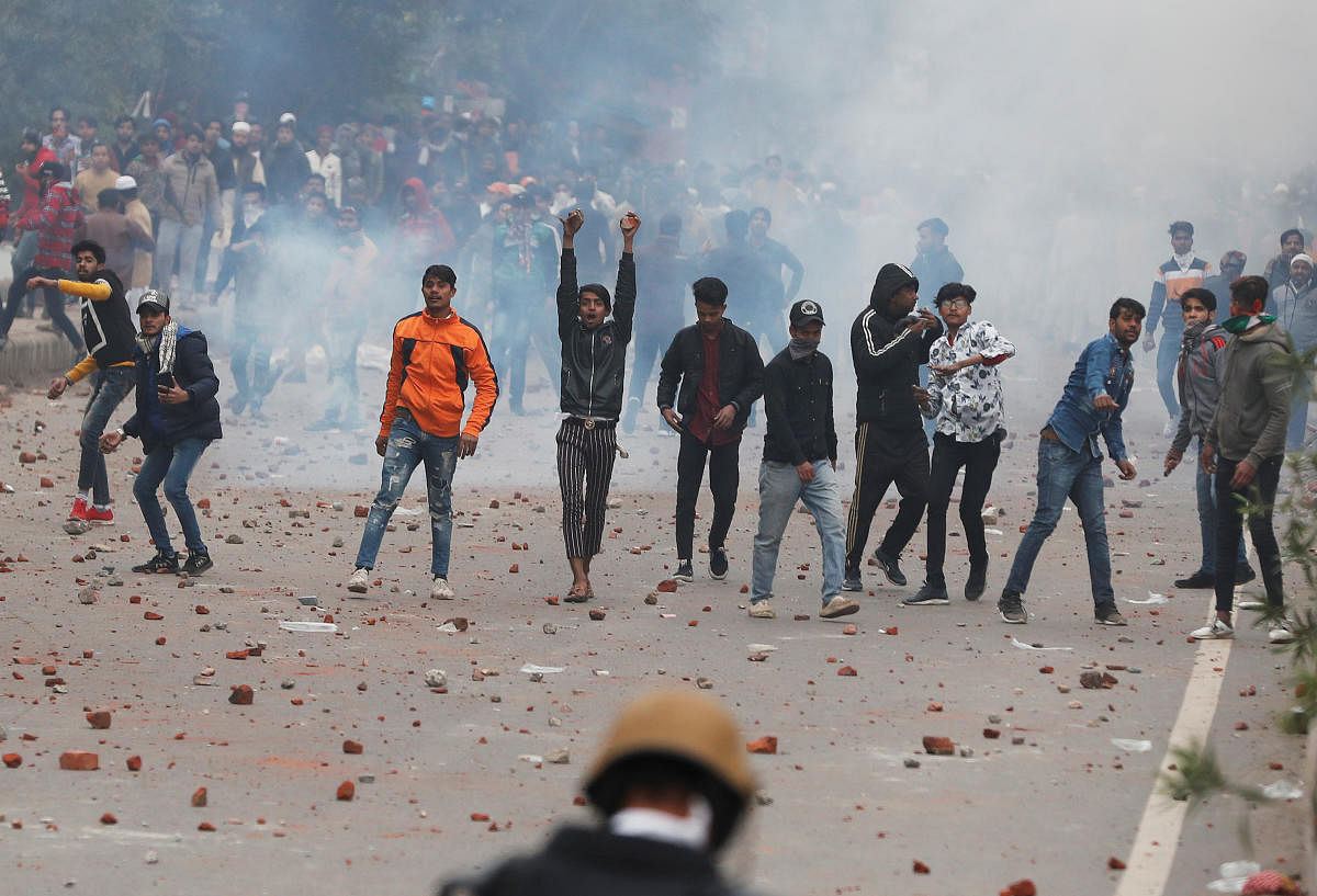Demonstrators threw stones towards police during a protest against the amended Citizenship Act in Seelampur area of Delhi. (REUTERS)