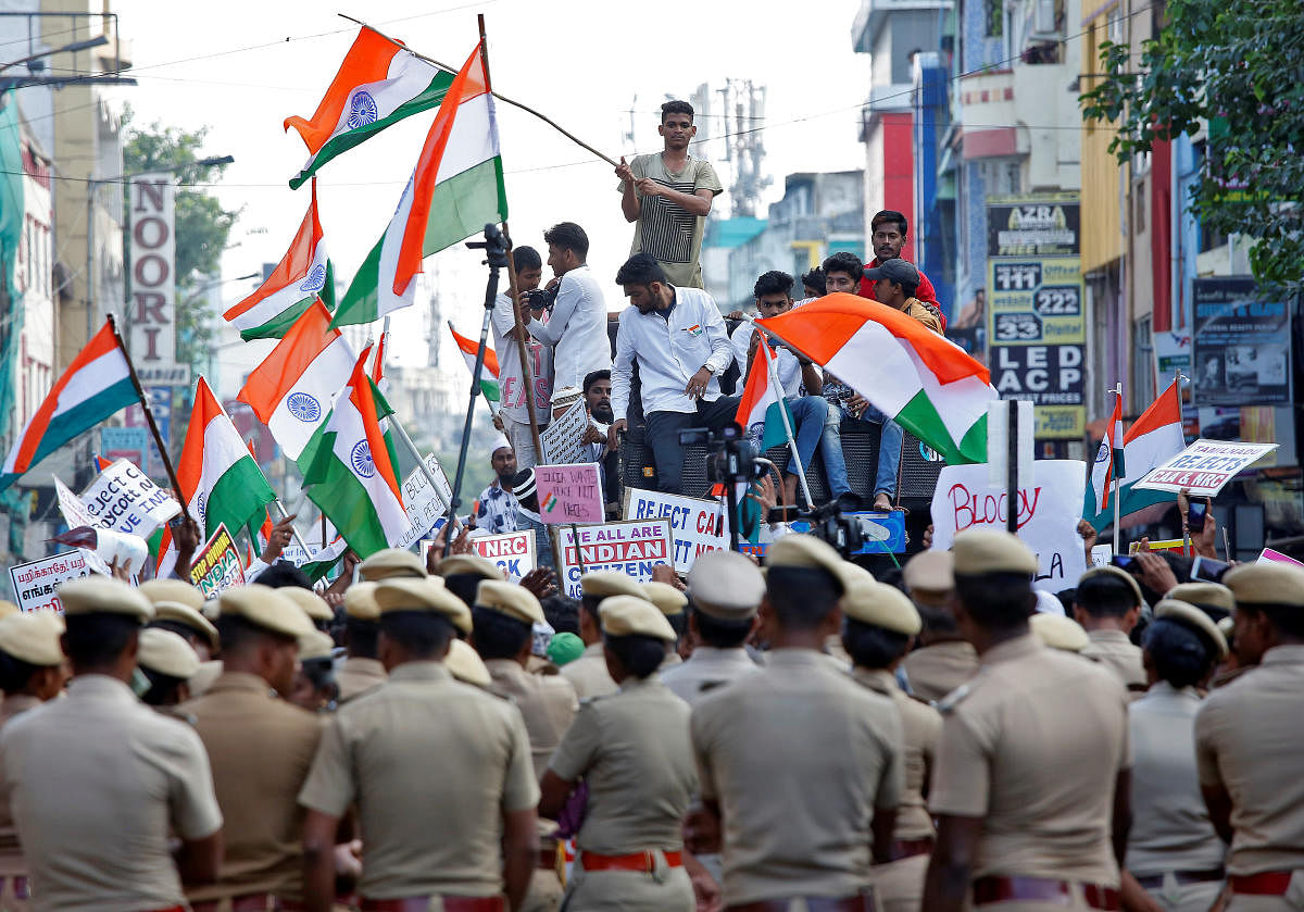 Police officers stand guard as demonstrators attend a protest march against a new citizenship law, in Chennai, India, December 22, 2019. (Reuters Photo)