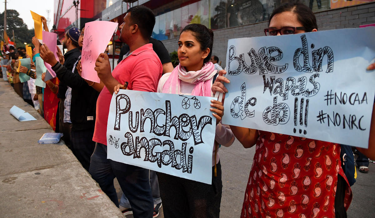 Protesters during a candlelight vigil against the CAA in Wilson Garden on Thursday. DH PHOTO/PUSHKAR V