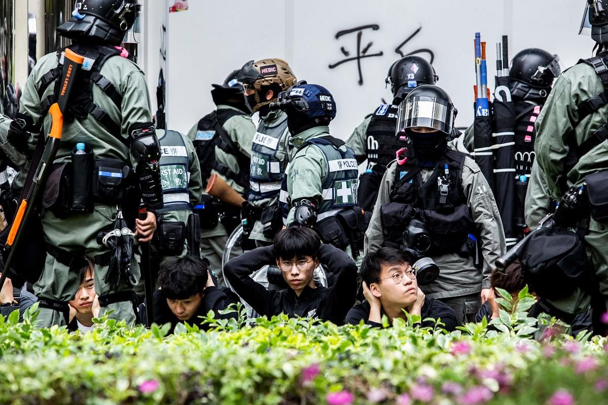 People are detained by police during a clearance operation after a demonstration against parallel trading in Sheung Shui in Hong Kong on January 5, 2020.  (Photo by ISAAC LAWRENCE / AFP)
