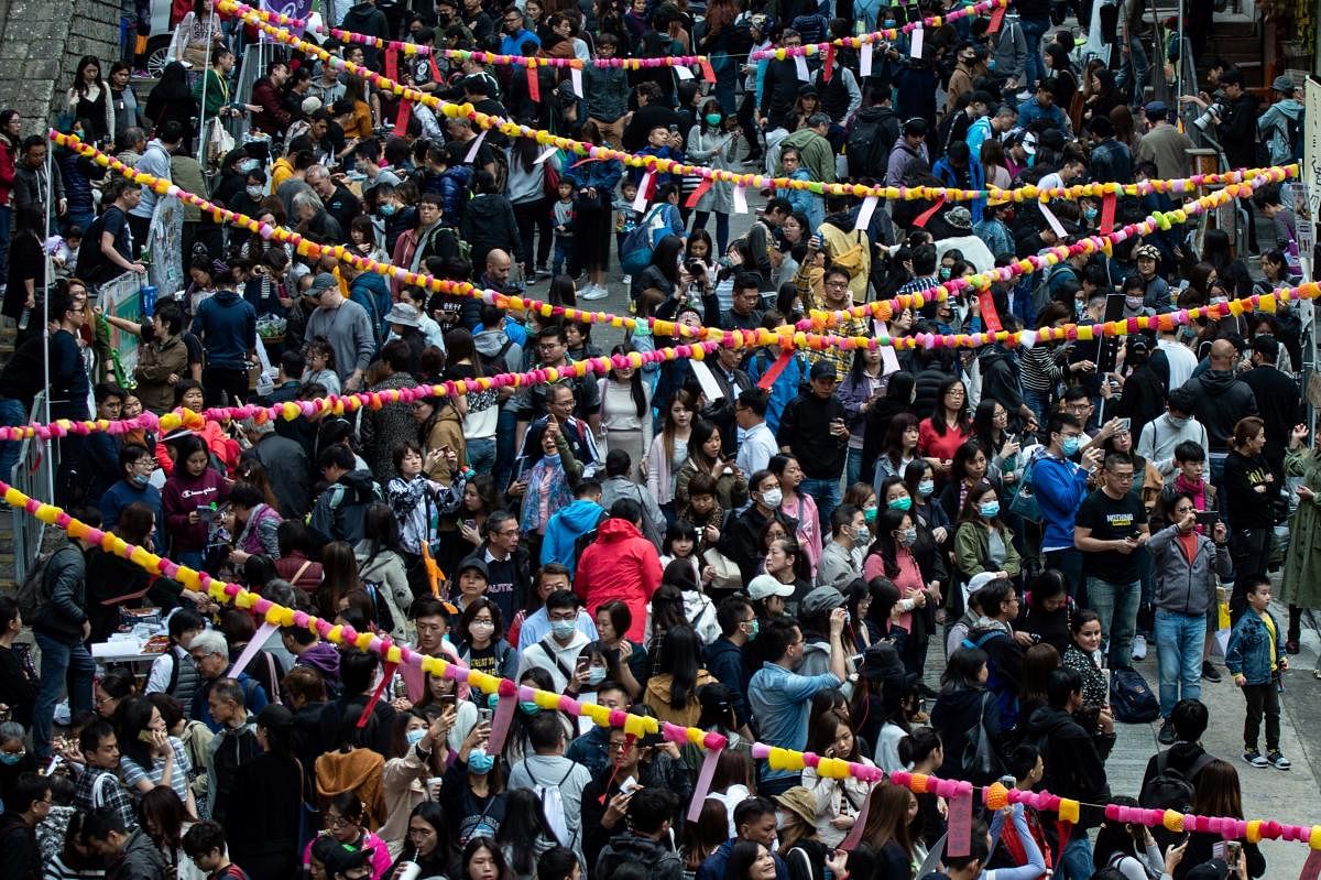 people taking part in a Lunar New Year fair organised by pro-democracy district councillors in the Sai Ying Pun district in Hong Kong. (AFP PHOTO)