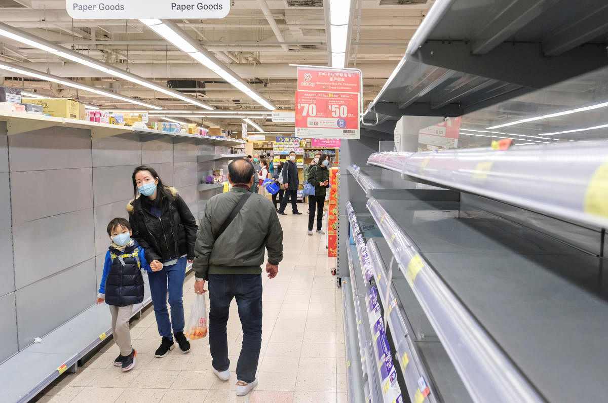 Customers wear masks as they walk past empty toilet paper shelves at a supermarket, following the outbreak of a new coronavirus, in Hong Kong, China February 6, 2020. (Reuters Photo)