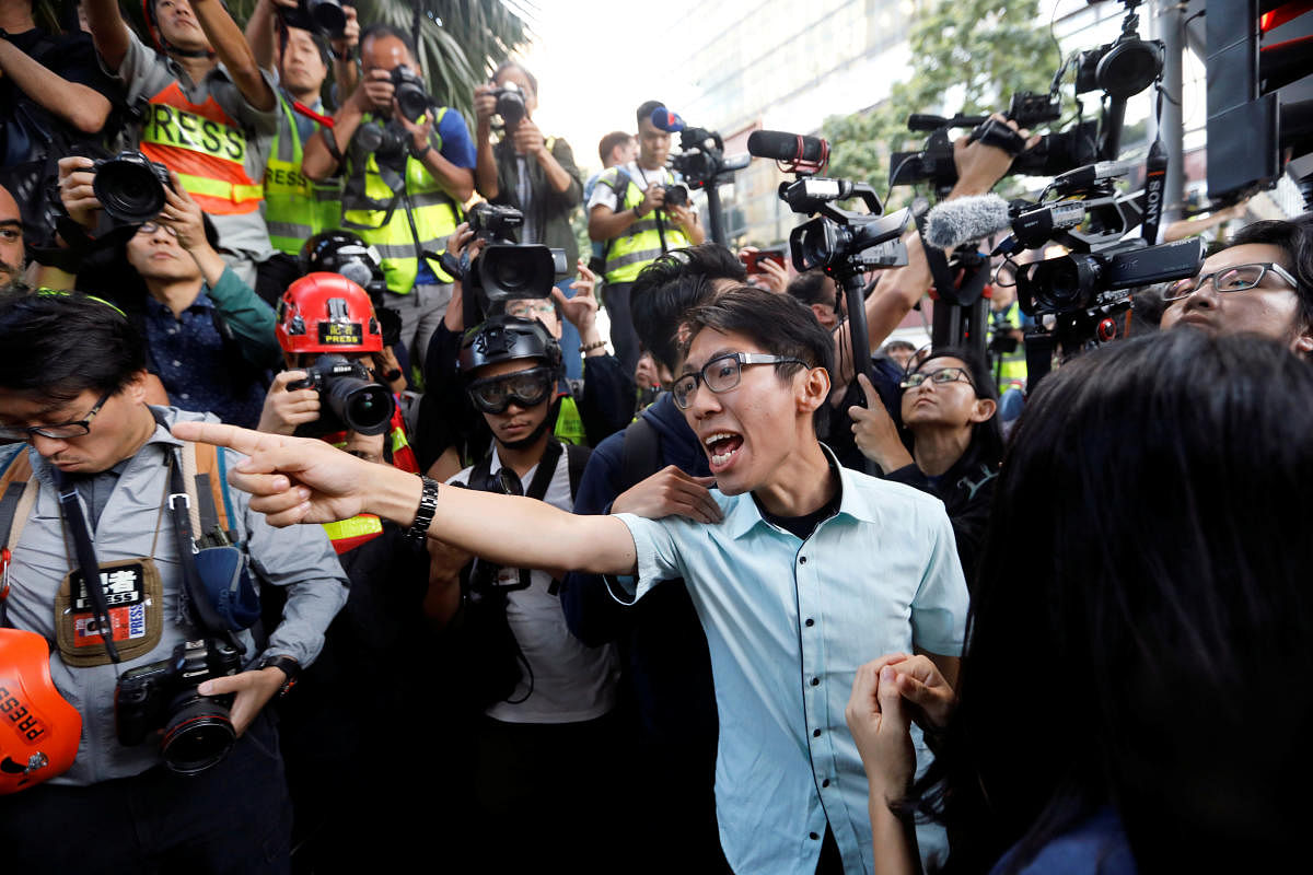 A pro-democratic winning candidate at district council local elections argues with police officers (not pictured) as they walk towards the campus of the Polytechnic University (PolyU) in Hong Kong. Reuters
