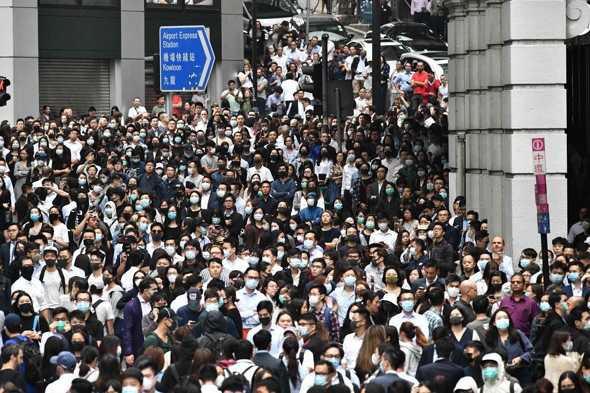 Office workers join pro-democracy protesters during a demonstration in Central in Hong Kong on November 12, 2019 following a day of pro-democracy protests. Photo/AFP