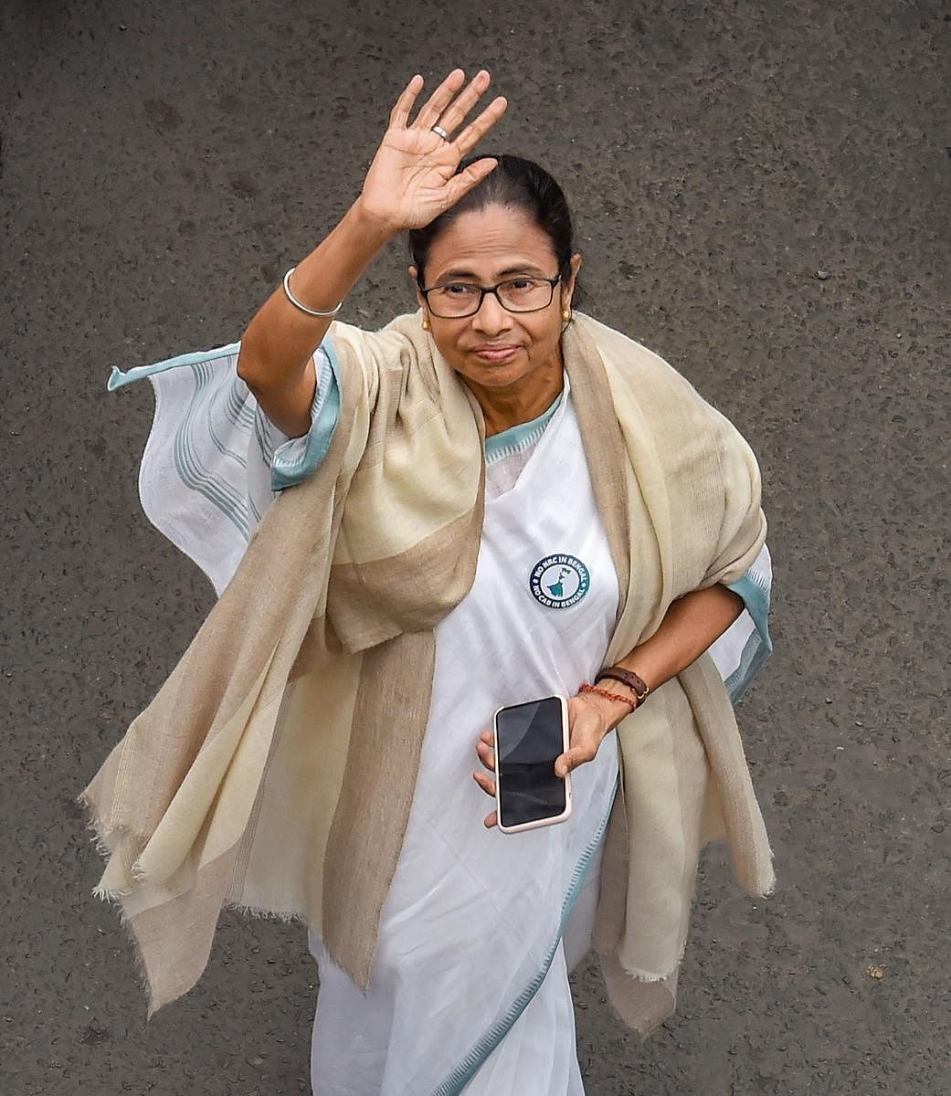 TMC Supremo and West Bengal Chief Minister Mamata Banerjee waves while leading a protest rally against the amended Citizenship Act and NRC, in Kolkata. PTI