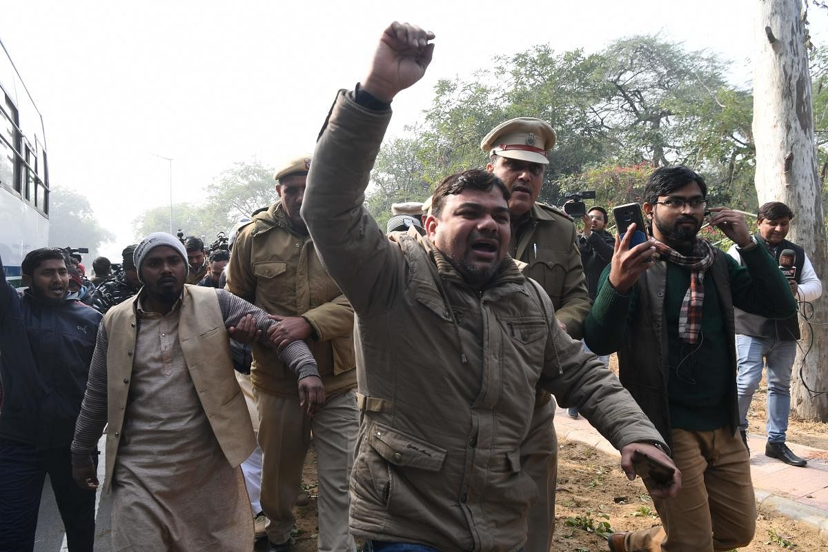 A protester shouts slogans after being detained outside the Uttar Pradesh Bhawan (state house) during a demonstration against the crackdown on protesters in Uttar Pradesh state over India's new citizenship law in New Delhi. AFP